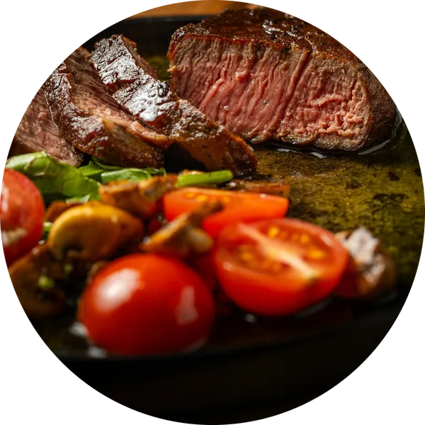 Sliced steak with cherry tomatoes