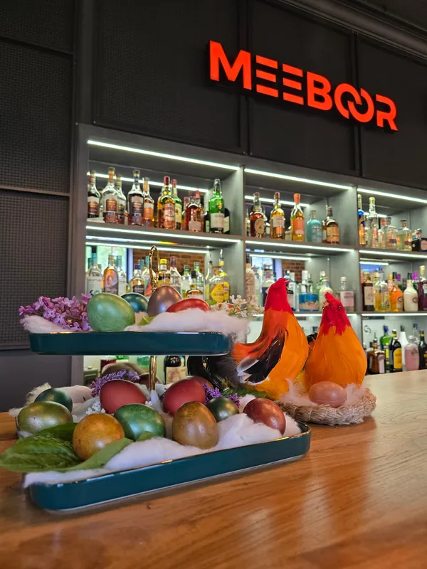 Shelves of bottles under the red Meeboor sign