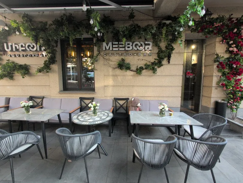 The terrace on Saryan Street: tables with flowers under the Meeboor sign