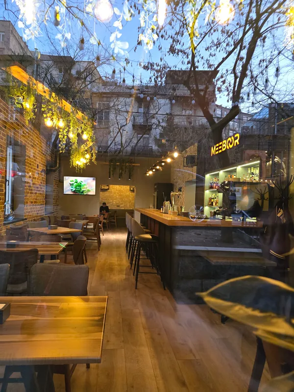The garden bar at dusk under string lights